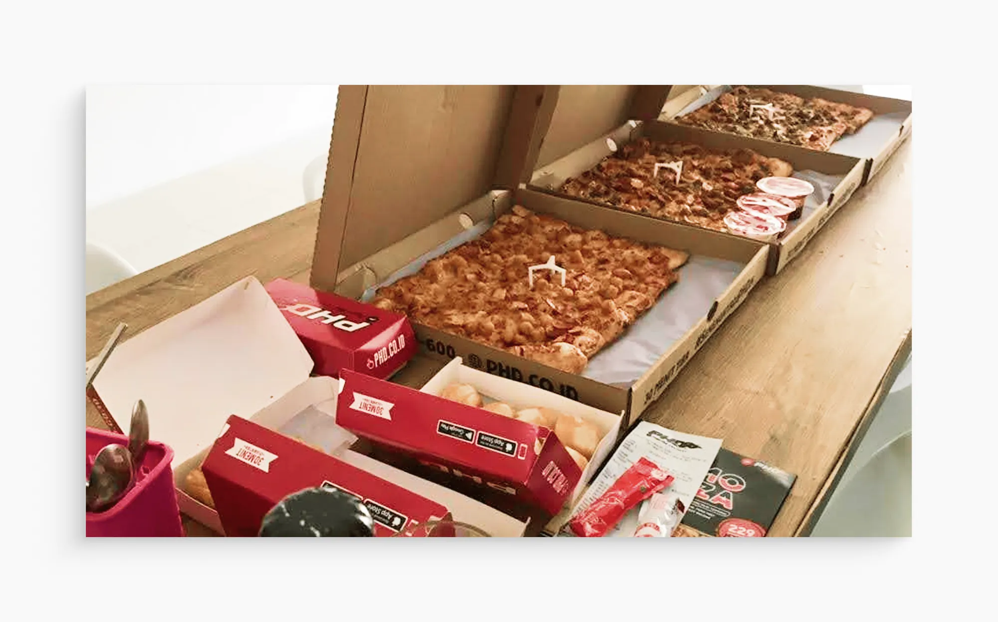 The team celebrating the website launch with a pizza party